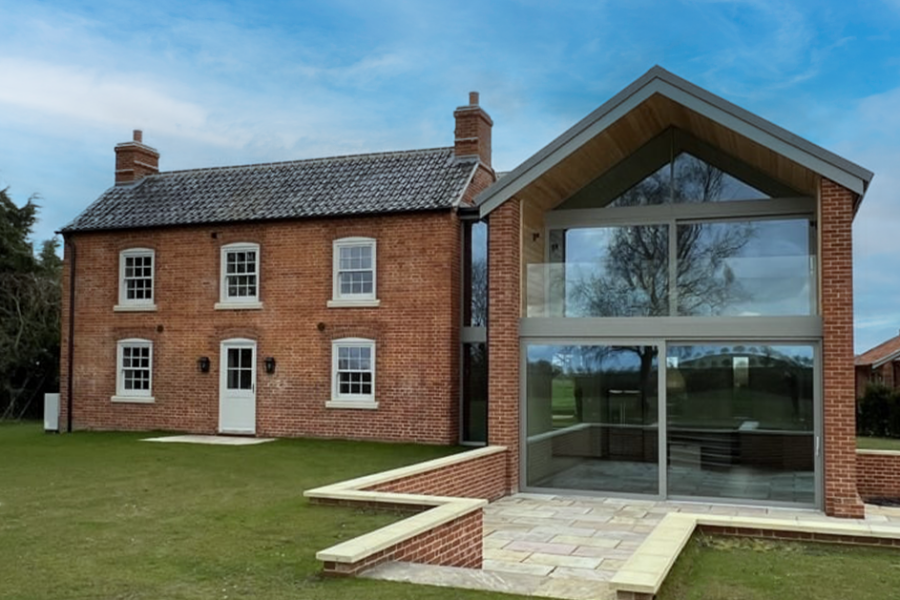 A brick house with a modern extension