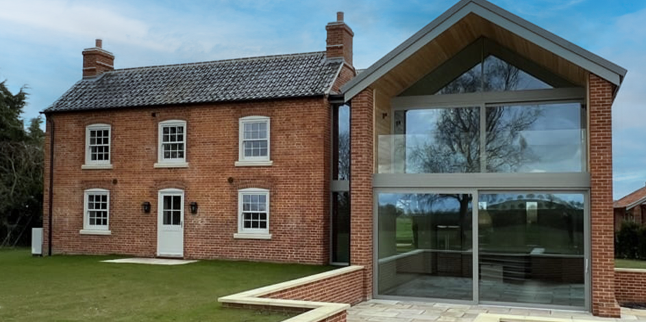 A brick house with a modern extension